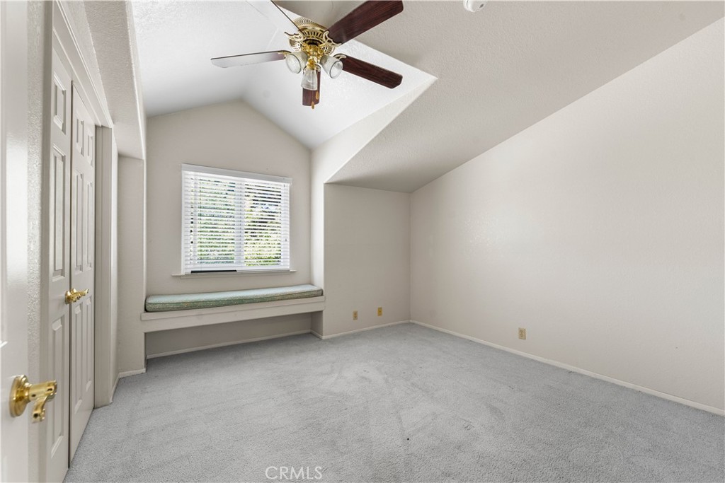 41058 Carmel Road Palmdale, CA 93551 - Photo 42 of 68 an empty room with chandelier fan and windows