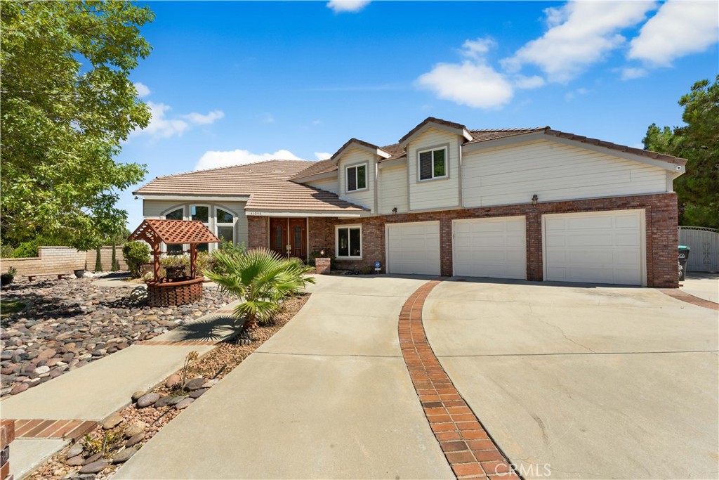 41058 Carmel Road Palmdale, CA 93551 - Photo 6 of 68 a front view of a house with a yard and garage