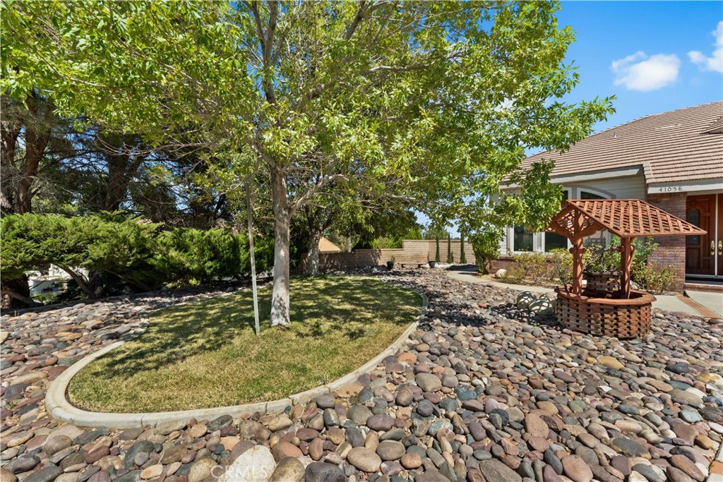 41058 Carmel Road Palmdale, CA 93551 - Photo 8 of 68 a backyard of a house with fountain table and chairs