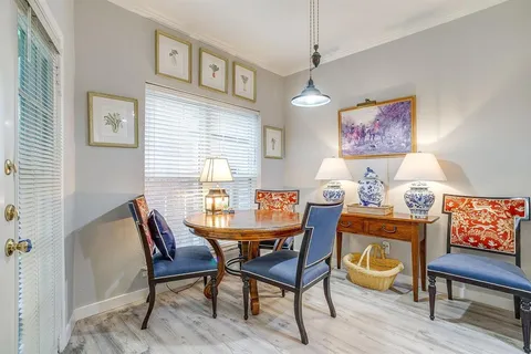 a dining room with furniture and window