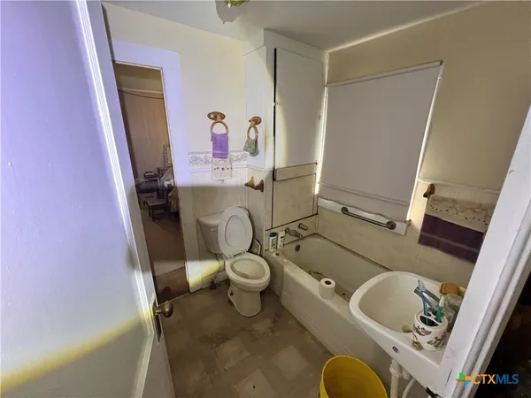 a bathroom with a sink toilet and mirror
