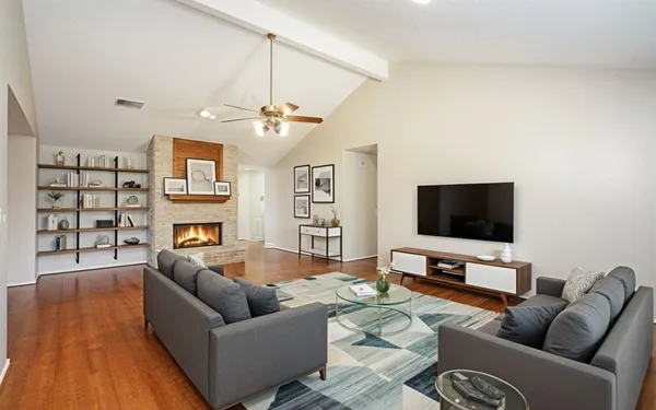 a living room with furniture and a flat screen tv
