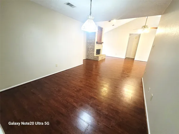 a view of a room with wooden floor and windows