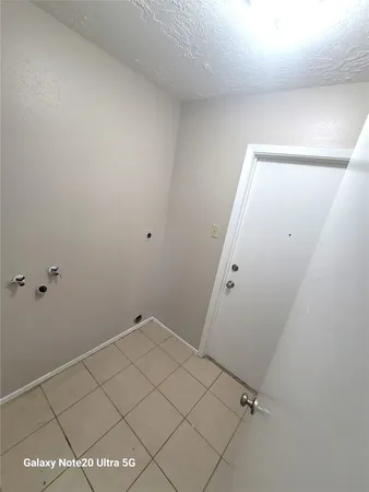 an empty room with a window and a ceiling fan