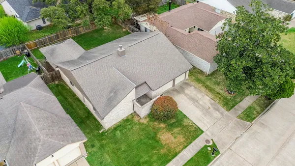 an aerial view of residential houses with outdoor space