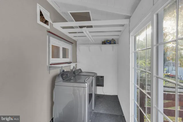 a bathroom with a granite countertop sink a mirror and shower