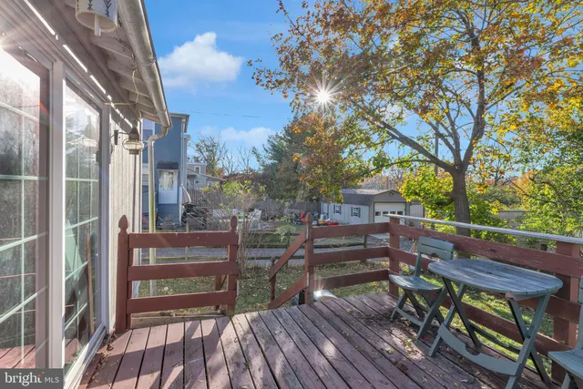 a view of balcony with wooden floor and outdoor seating