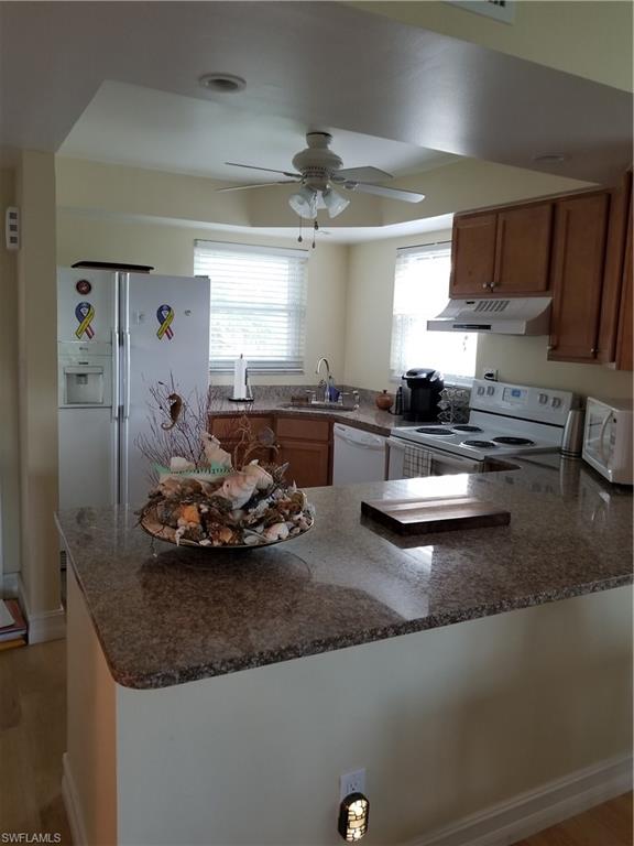 49 High Point Circle South, Unit 101 Naples, FL 34103 - Photo 3 of 8 Renovated kitchen with new appliances, cabinets and granite counter top