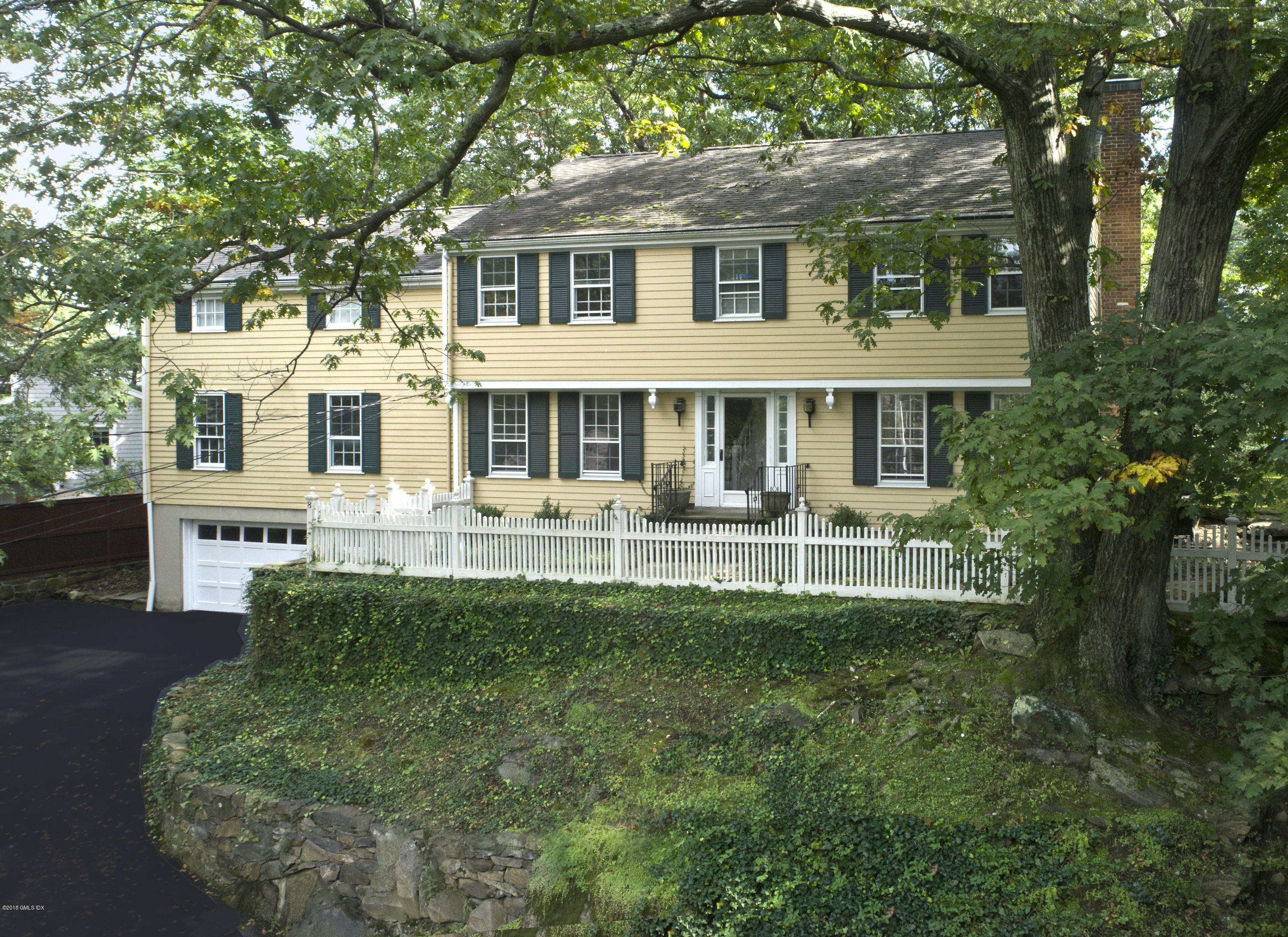 a front view of a house with a yard table and chairs