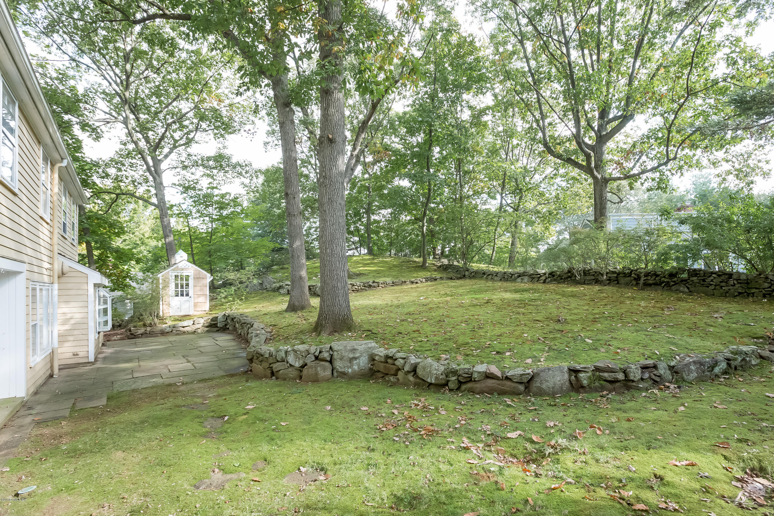 8 Skylark Road Greenwich, CT 06830 - Photo 12 of 15 a backyard of a house with lots of green space