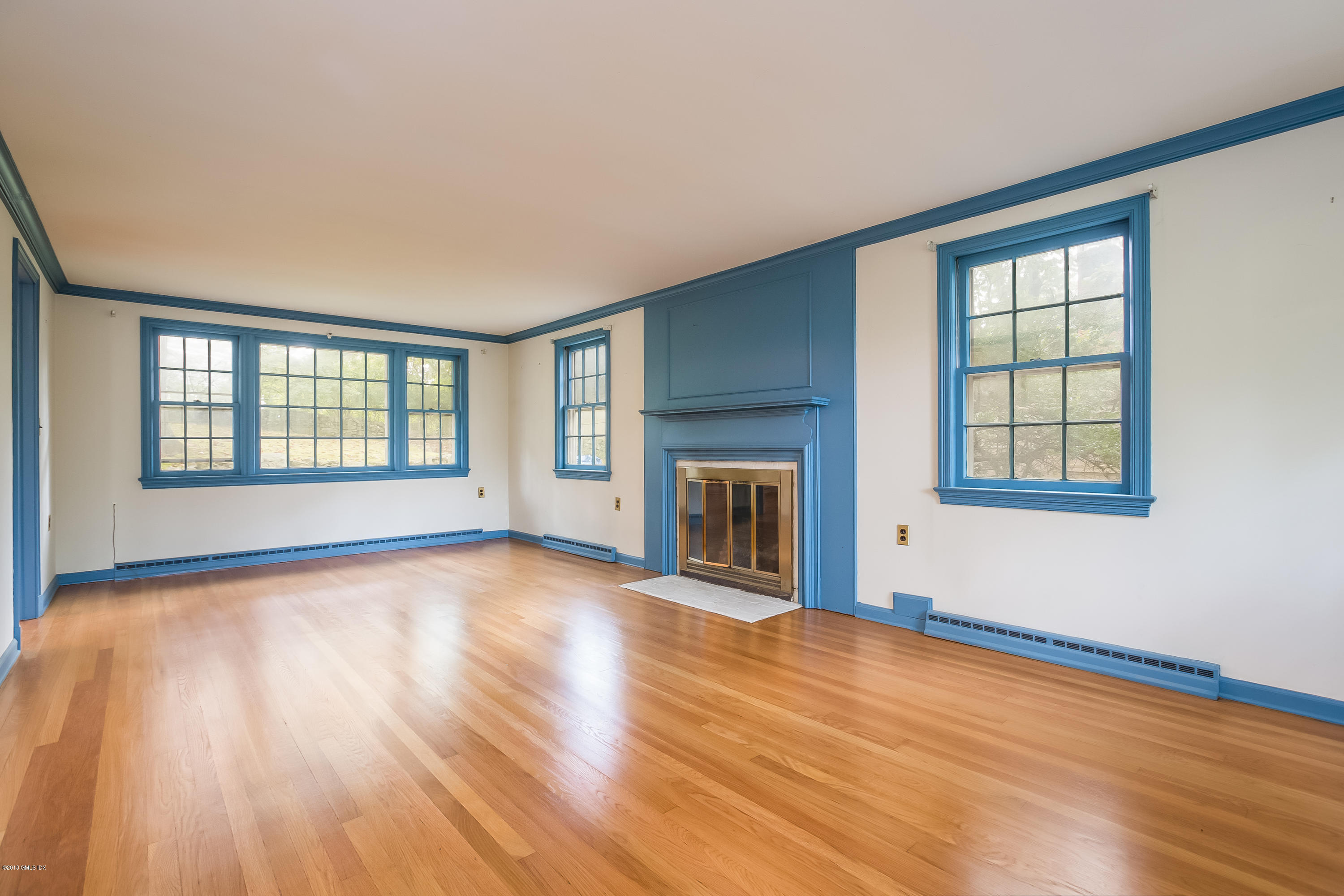 8 Skylark Road Greenwich, CT 06830 - Photo 3 of 15 a view of an empty room with window and wooden floor