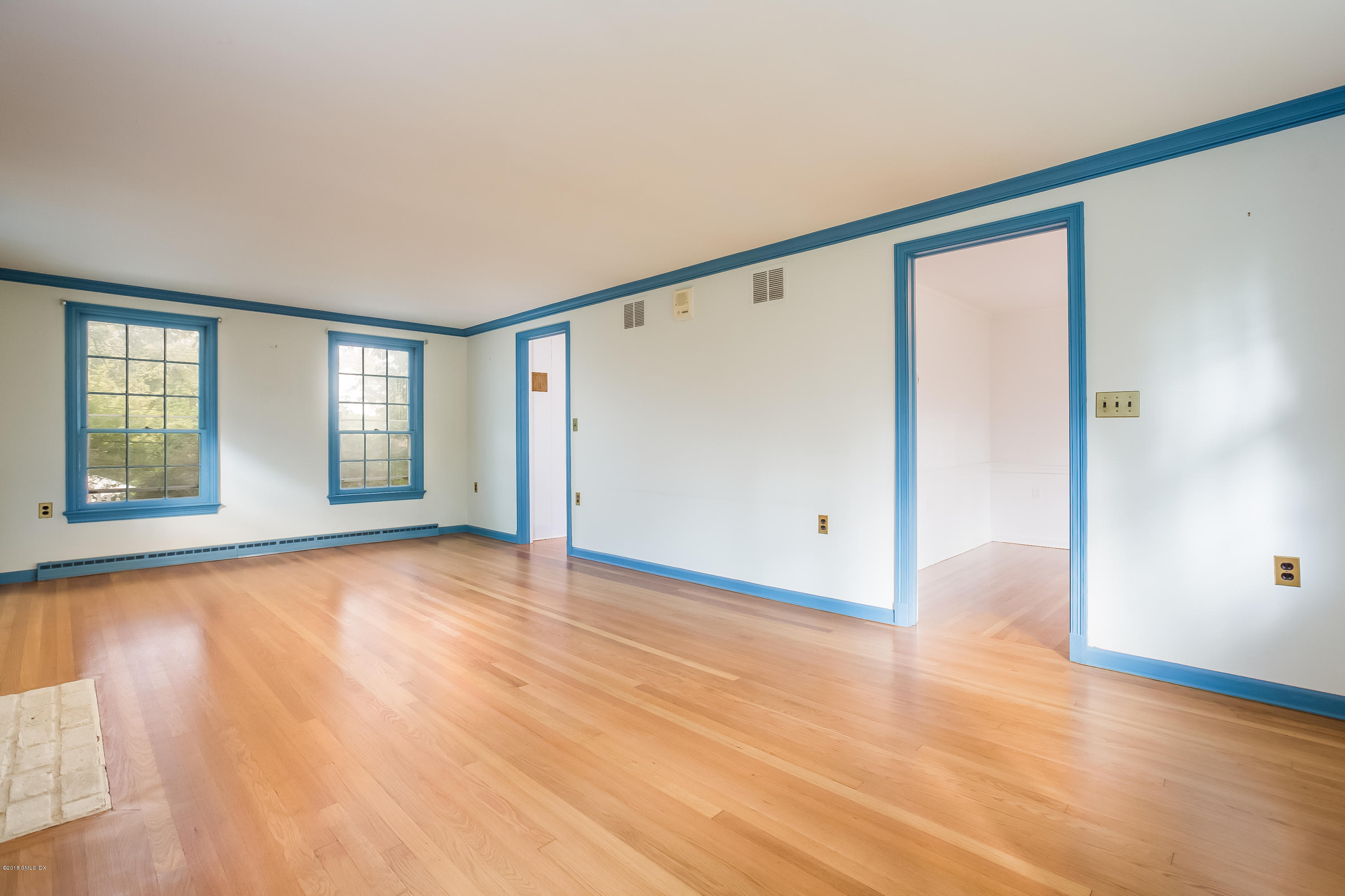 8 Skylark Road Greenwich, CT 06830 - Photo 4 of 15 a view of an empty room with window and wooden floor