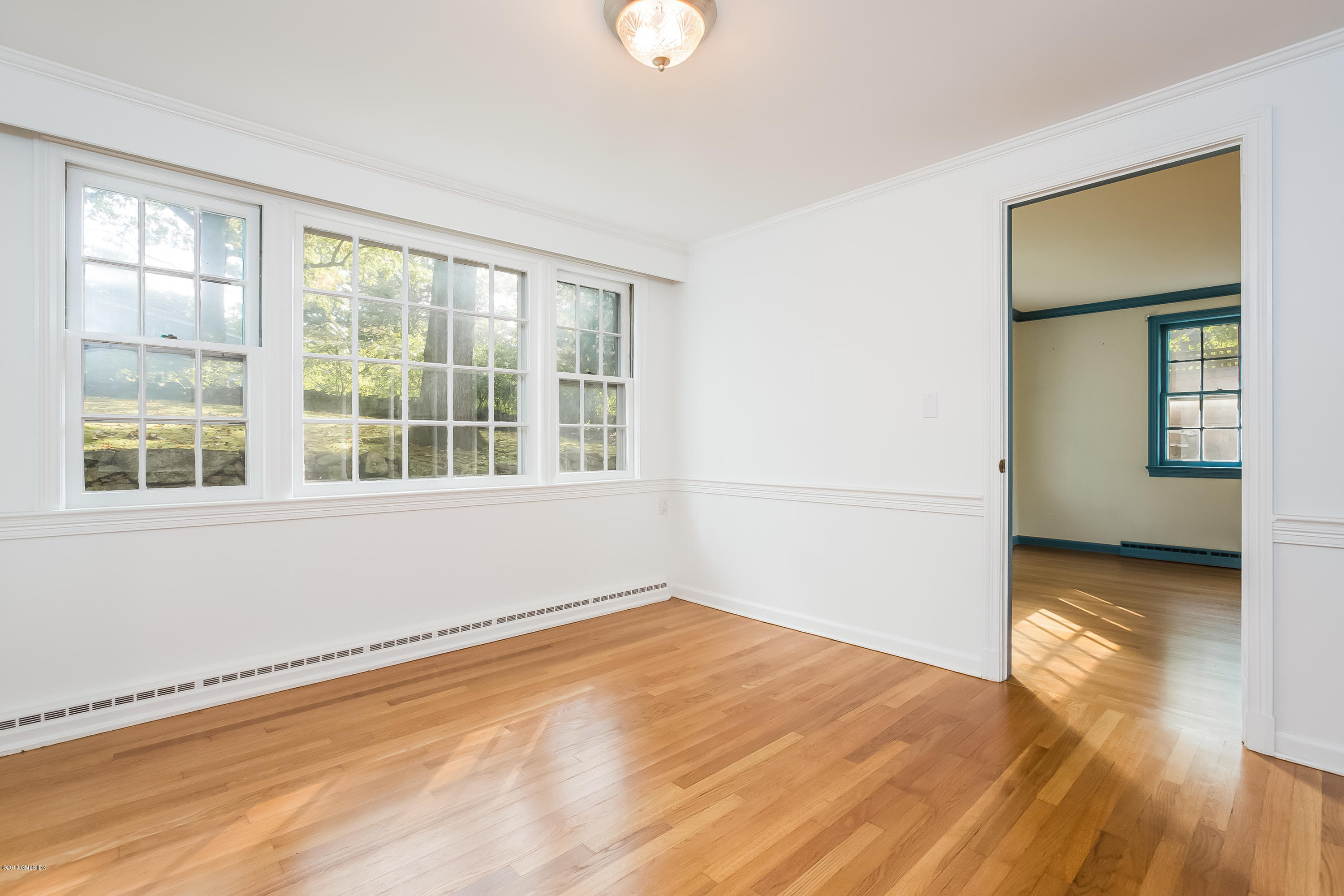 8 Skylark Road Greenwich, CT 06830 - Photo 6 of 15 a view of empty room with wooden floor and fan