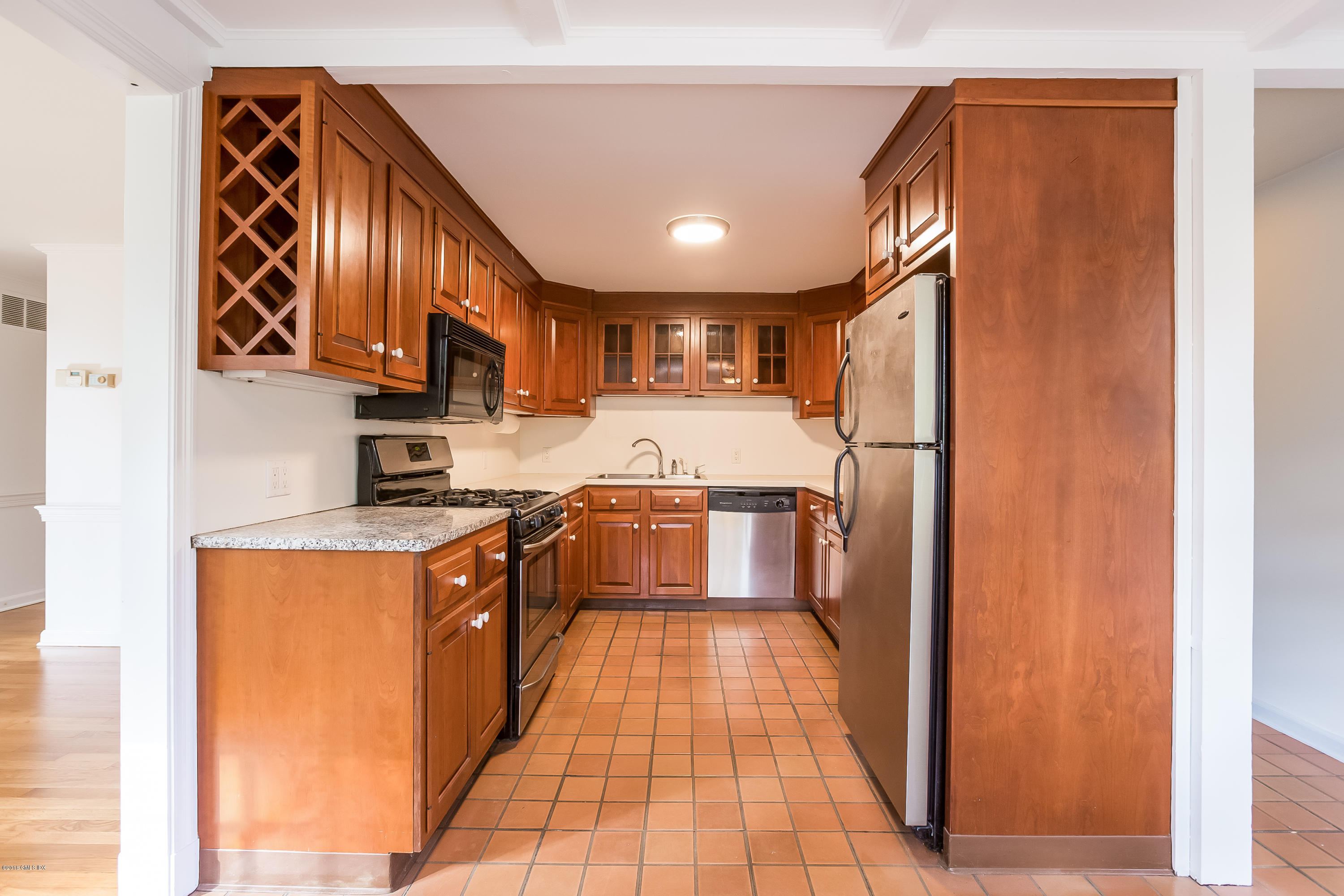 8 Skylark Road Greenwich, CT 06830 - Photo 8 of 15 a large kitchen with stainless steel appliances granite countertop a stove and a refrigerator