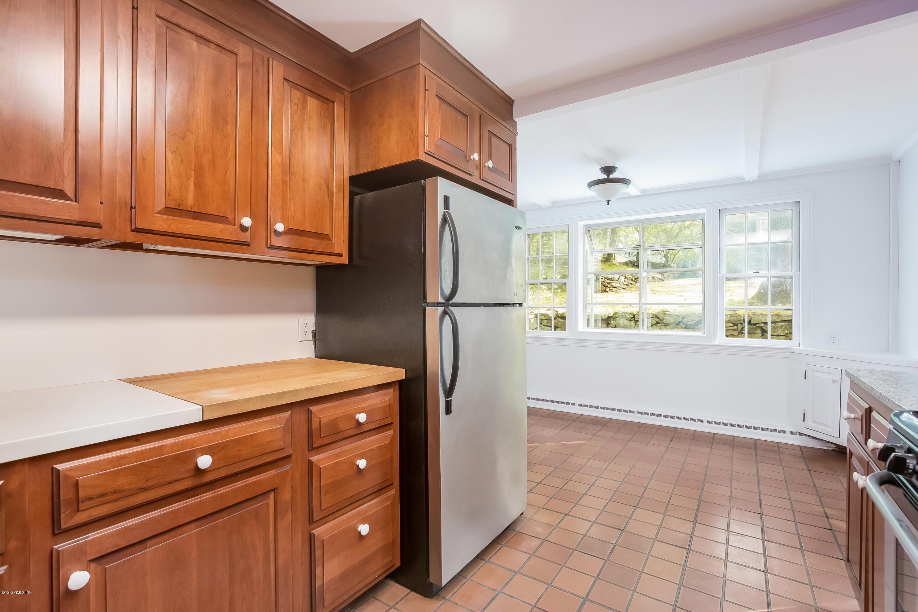 8 Skylark Road Greenwich, CT 06830 - Photo 9 of 15 a kitchen with stainless steel appliances granite countertop a refrigerator and a stove top oven