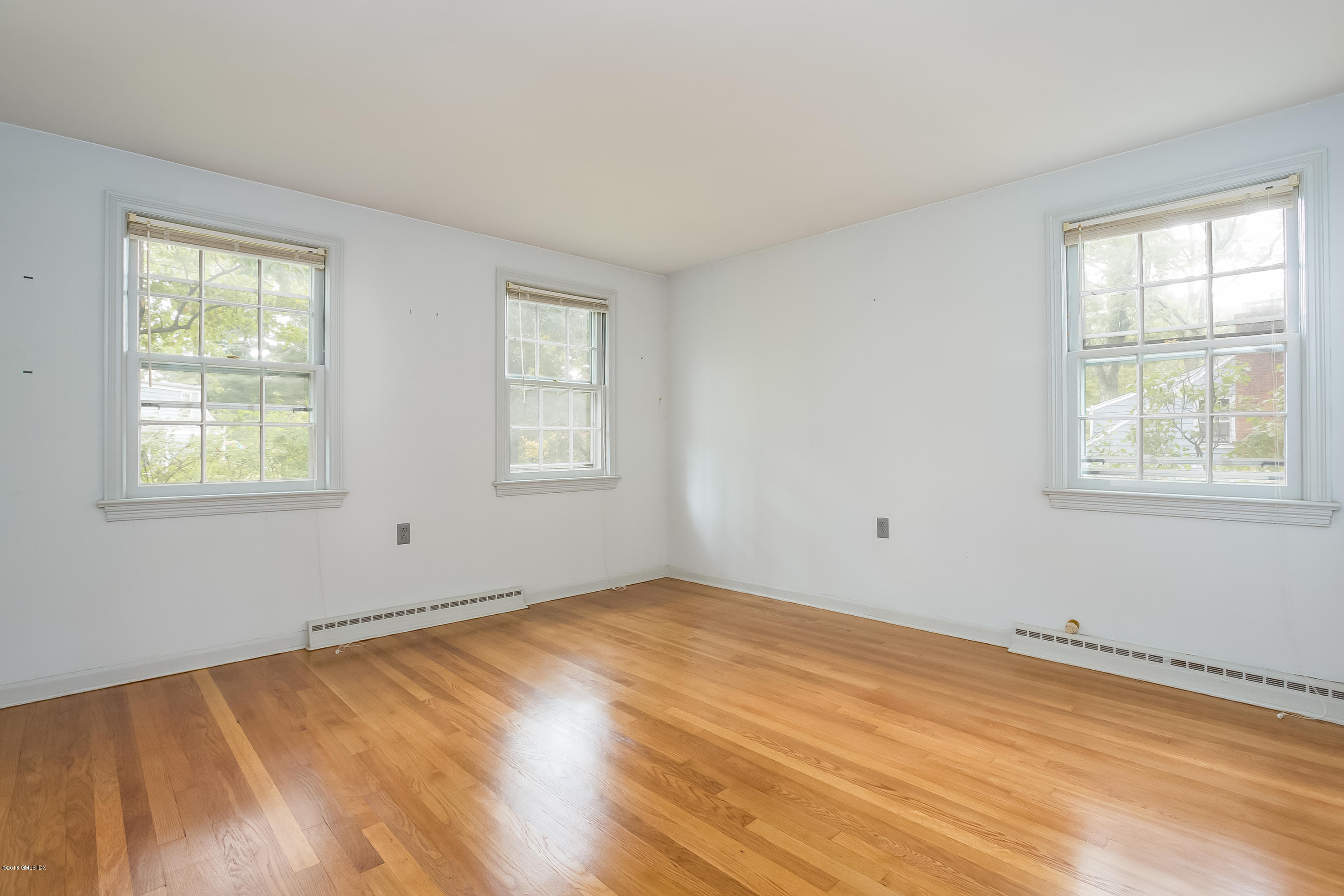 8 Skylark Road Greenwich, CT 06830 - Photo 10 of 15 a view of an empty room with wooden floor and a window