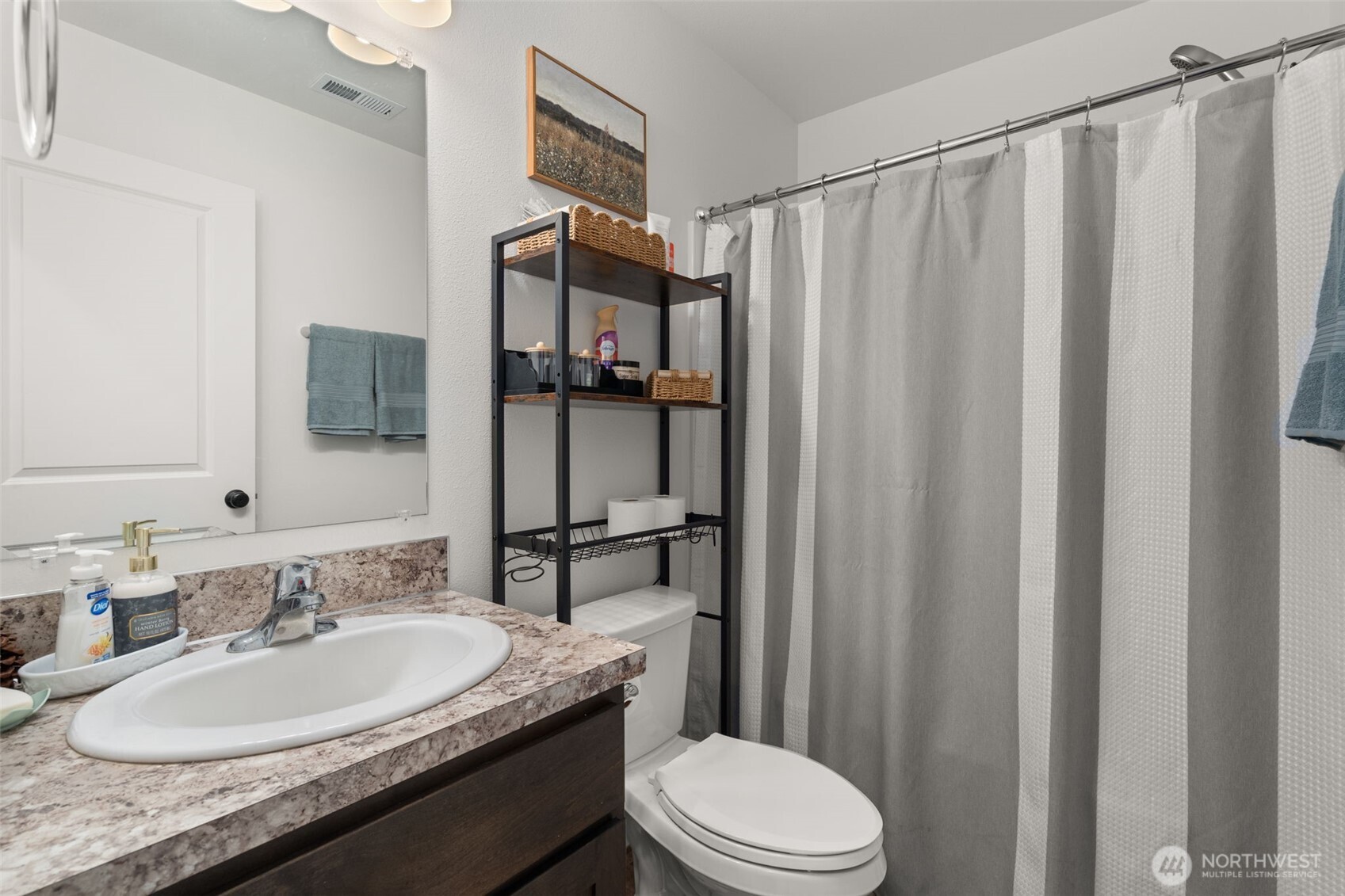 401 Cardinal Avenue Winlock, WA 98596 - Photo 19 of 39 a bathroom with a granite countertop sink toilet and shower