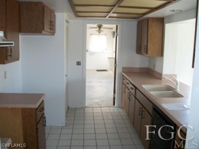 26450 Brooks Road Punta Gorda, FL 33955 - Photo 7 of 9 a kitchen with a sink stove and cabinets