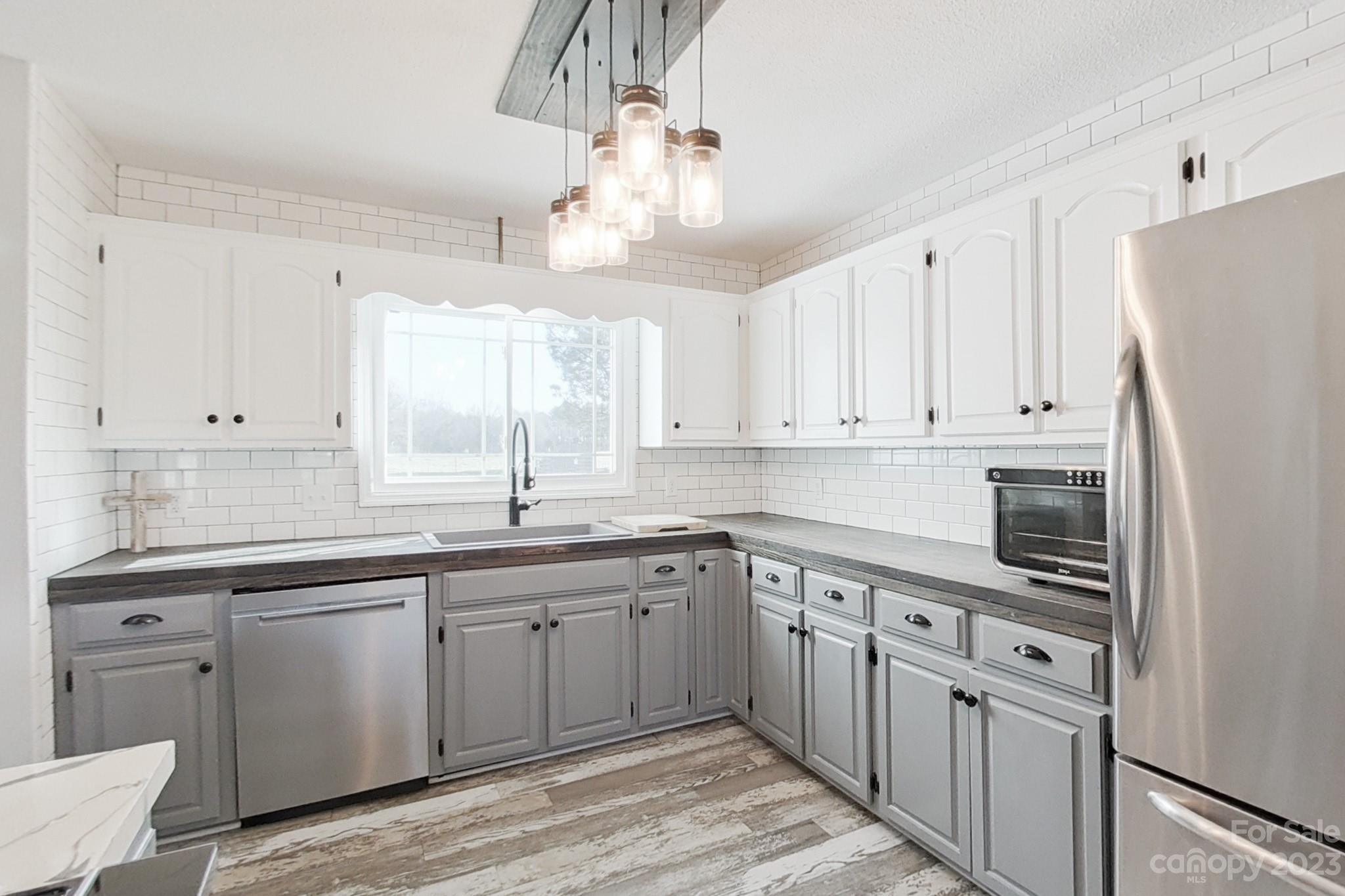 8176 Renee Ford Road Stanfield, NC 28163 - Photo 16 of 48 a kitchen with a sink a window and cabinets