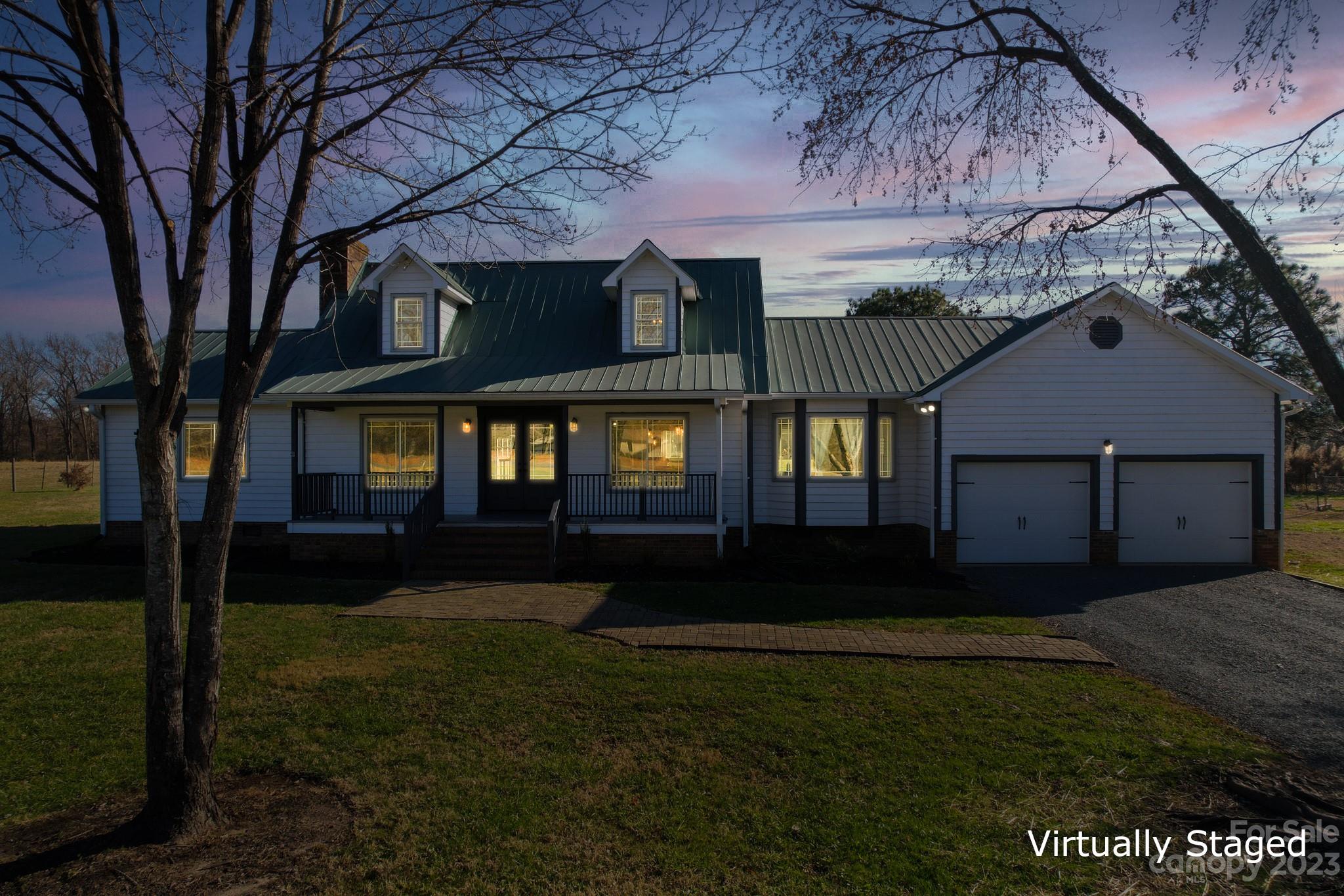 8176 Renee Ford Road Stanfield, NC 28163 - Photo 2 of 48 a house view with a garden space