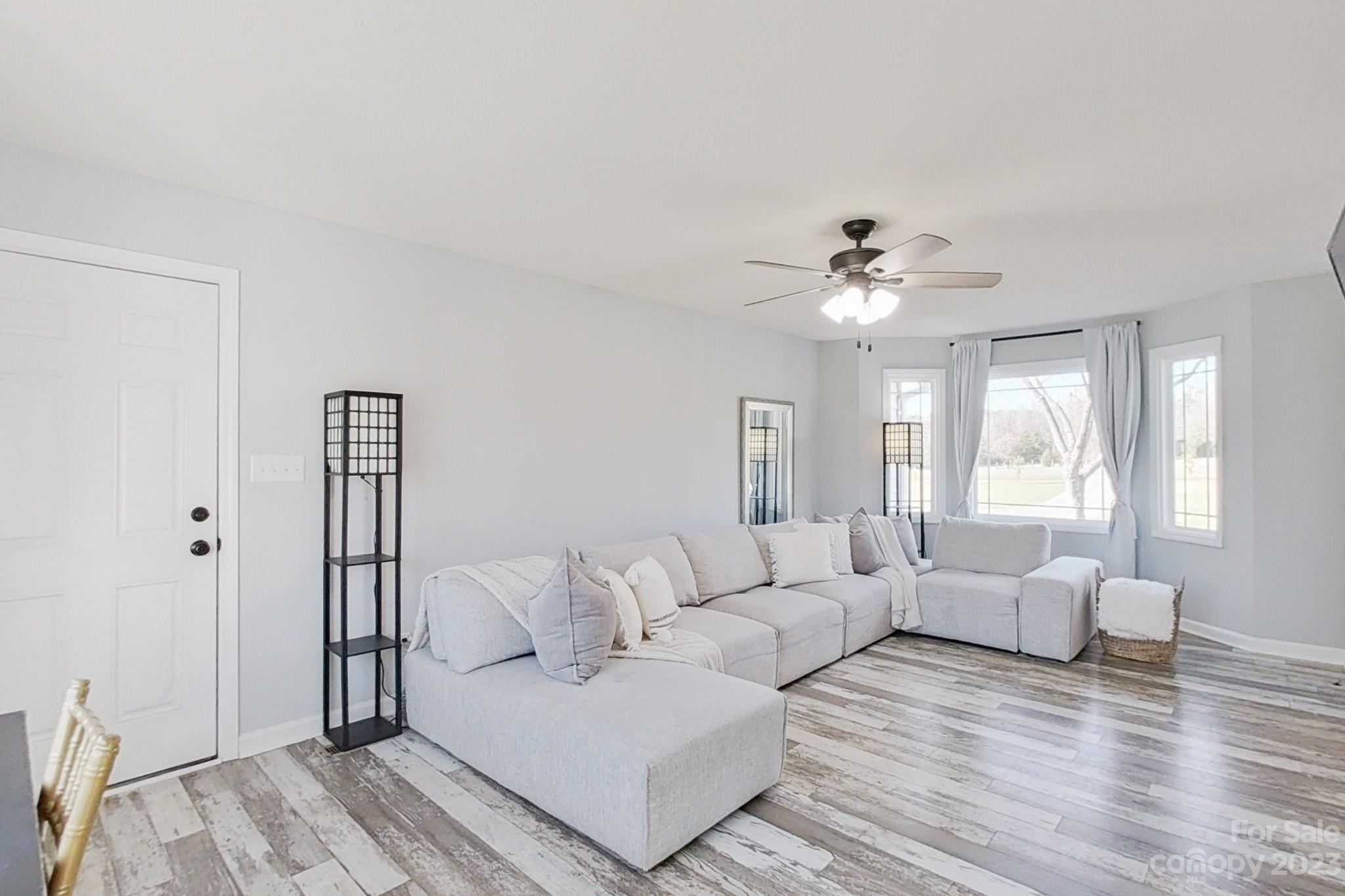 8176 Renee Ford Road Stanfield, NC 28163 - Photo 21 of 48 a living room with furniture and a chandelier