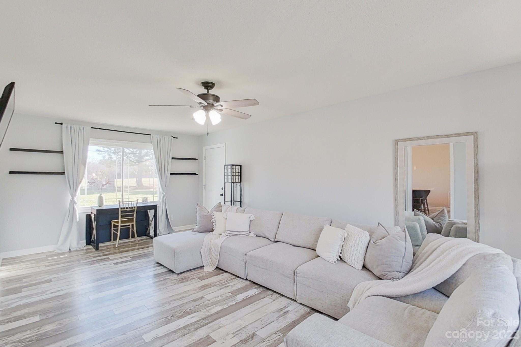 8176 Renee Ford Road Stanfield, NC 28163 - Photo 23 of 48 a living room with furniture and a large window