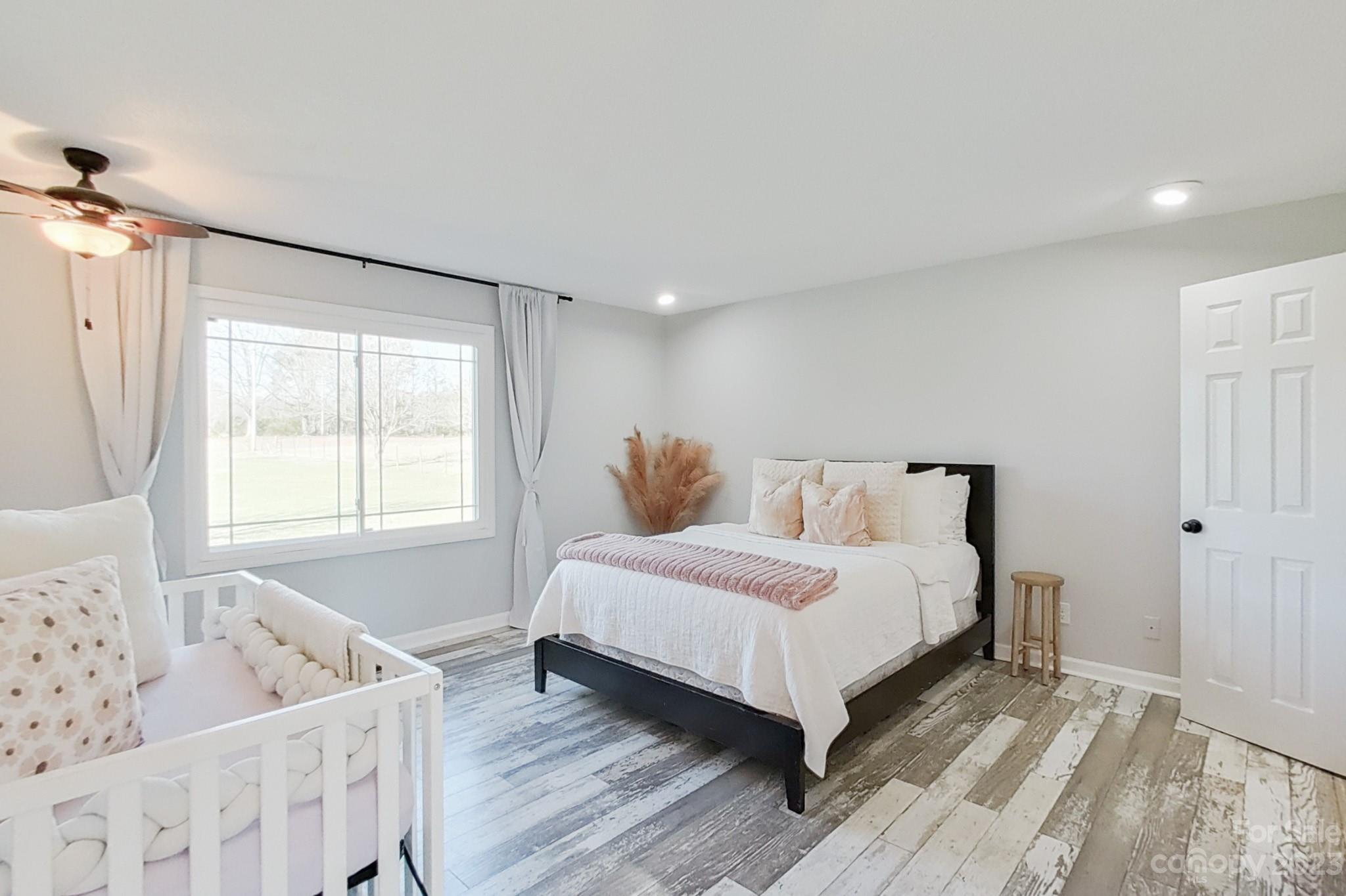 8176 Renee Ford Road Stanfield, NC 28163 - Photo 27 of 48 a spacious bedroom with a bed and a window