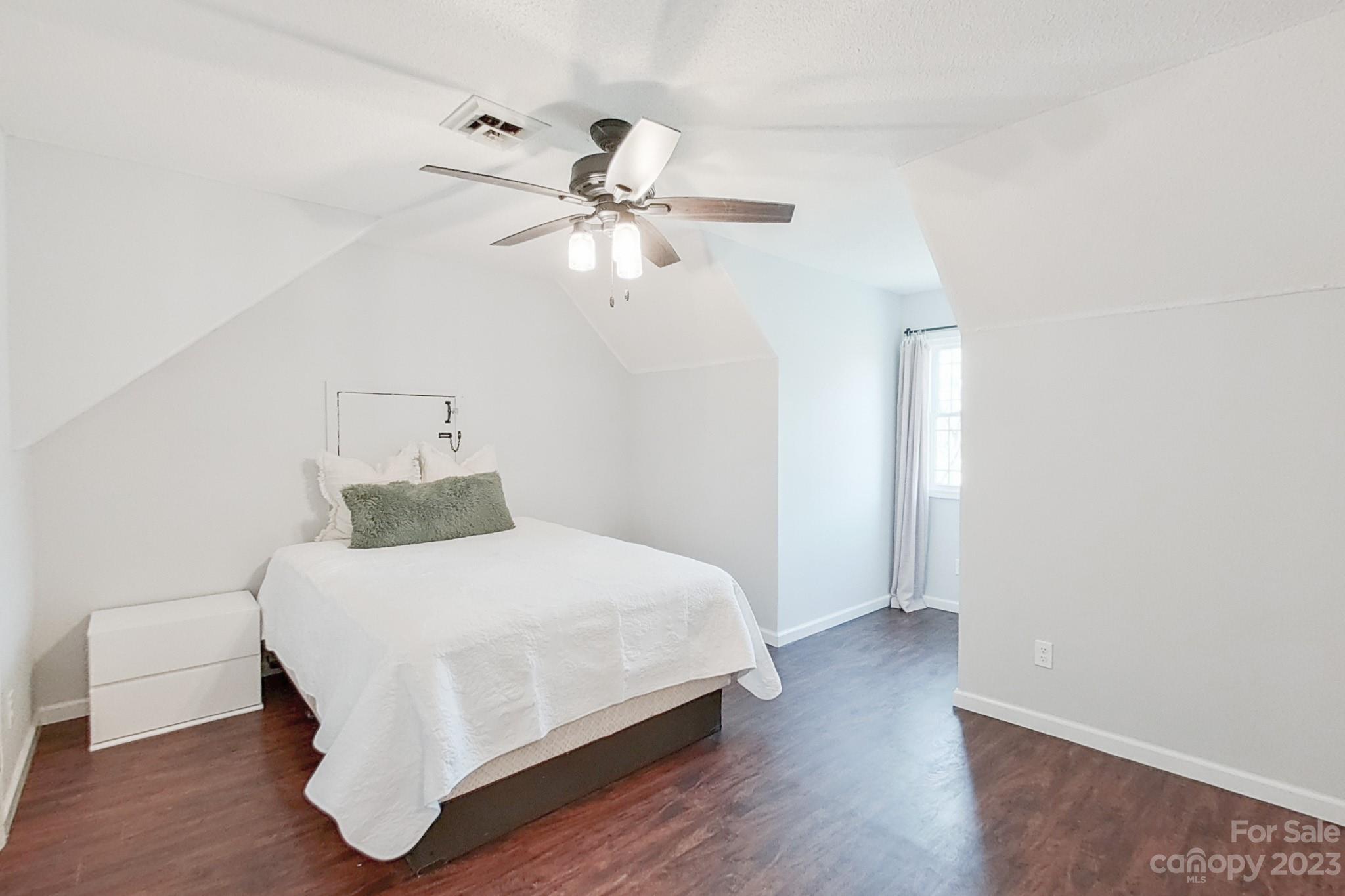8176 Renee Ford Road Stanfield, NC 28163 - Photo 34 of 48 a bedroom with a bed and a ceiling fan
