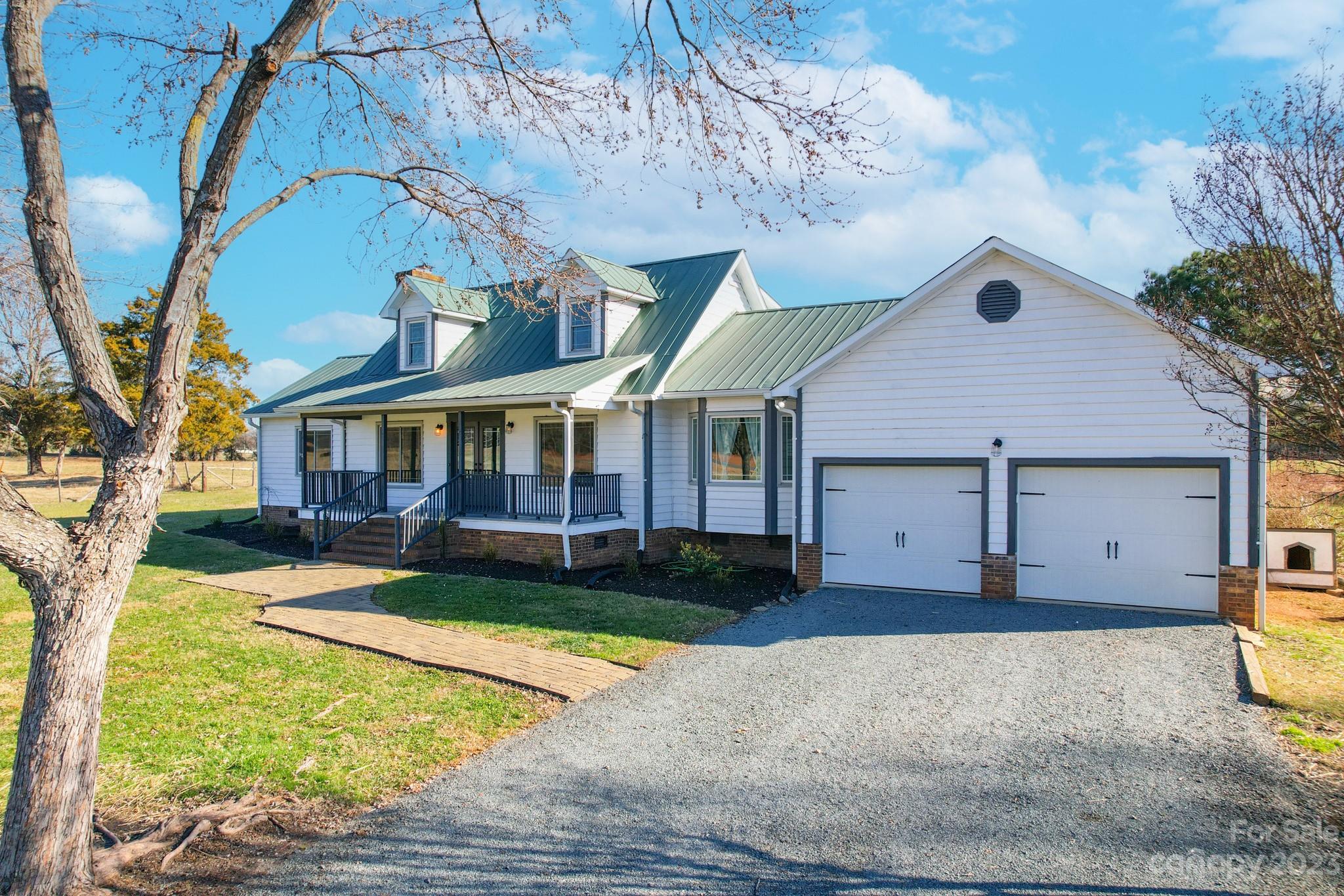 8176 Renee Ford Road Stanfield, NC 28163 - Photo 4 of 48 a front view of a house with a yard and garage
