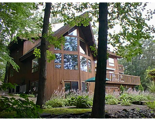 a view of a tree in front of a house
