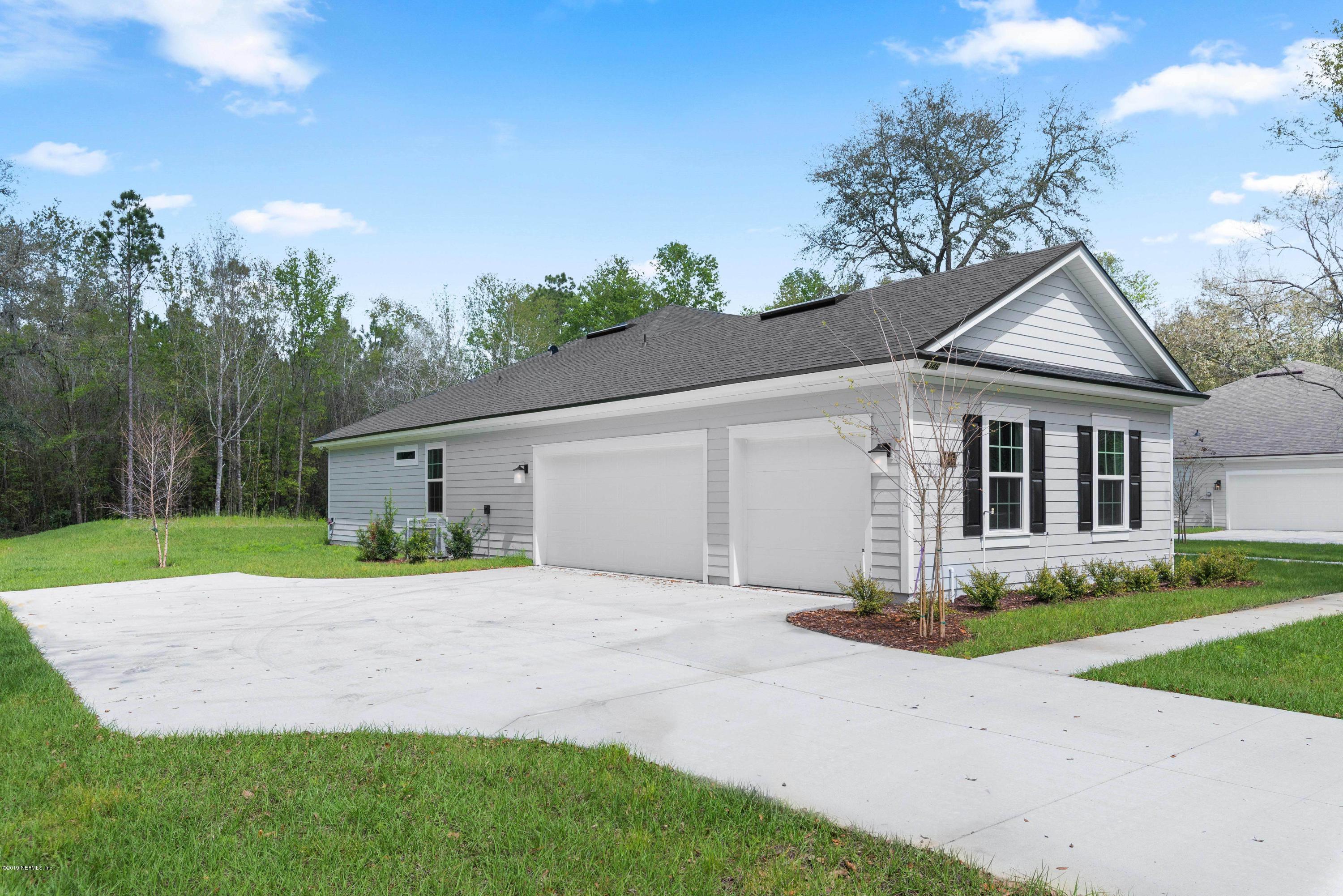 4046 Old Jennings Road Middleburg, FL 32068 - Photo 3 of 46 a front view of a house with a yard and garage