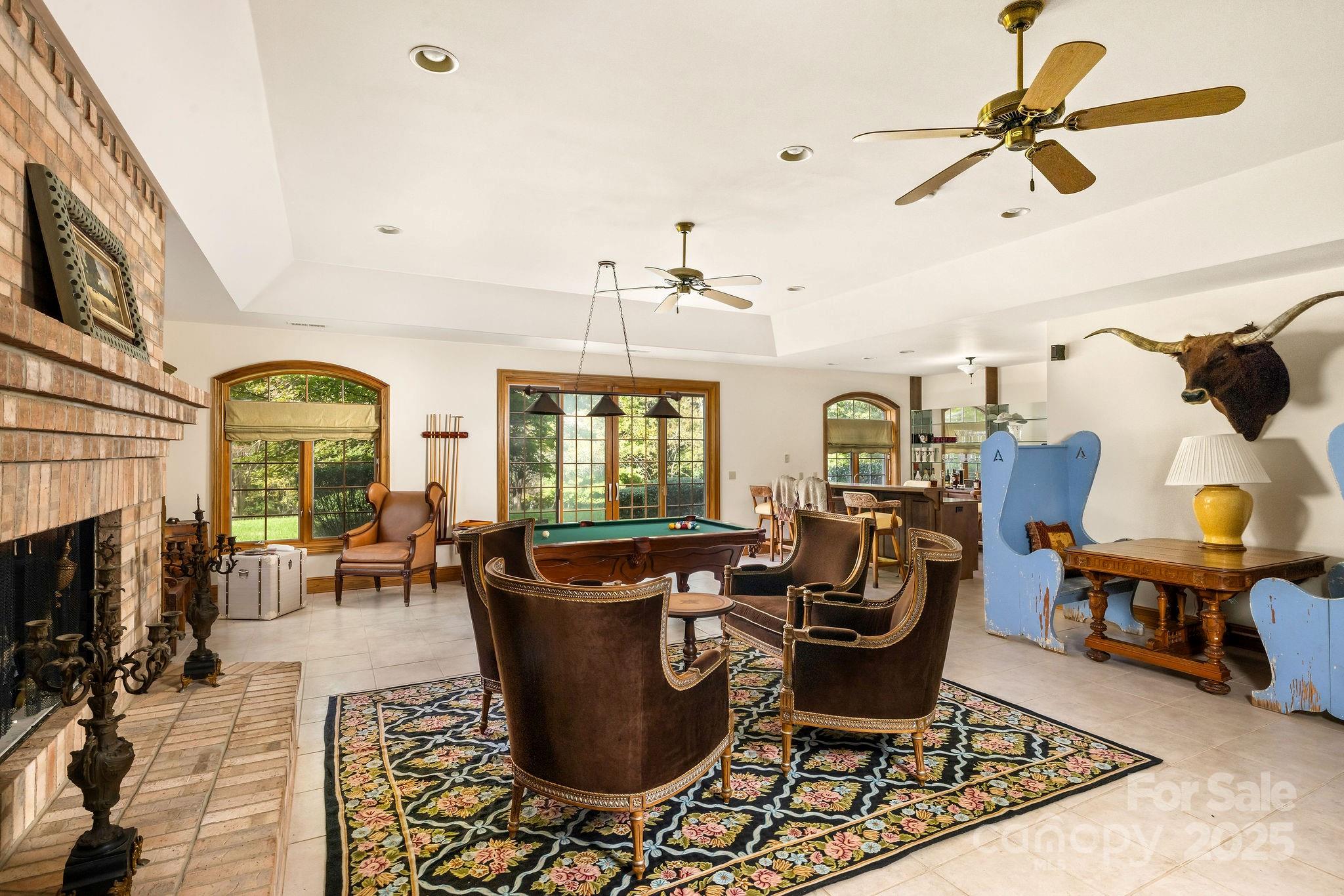 282 Hamilton Drive Columbus, NC 28722 - Photo 27 of 46 a living room with furniture a fireplace and a chandelier