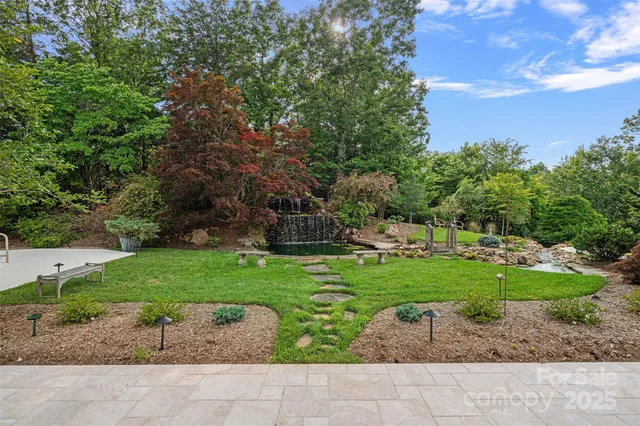 a backyard of a house with a garden and outdoor seating