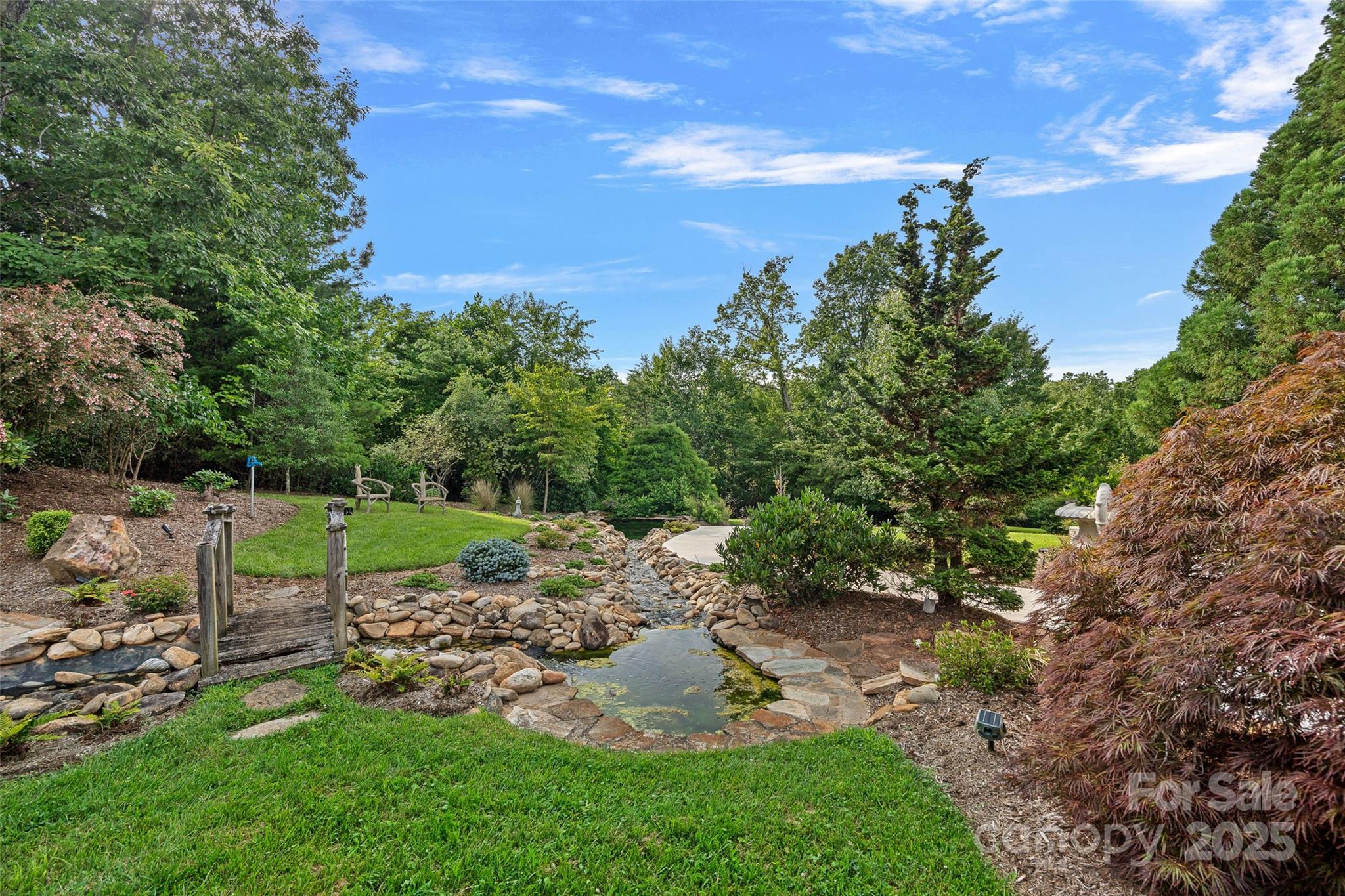 282 Hamilton Drive Columbus, NC 28722 - Photo 31 of 46 a view of a garden with a large tree