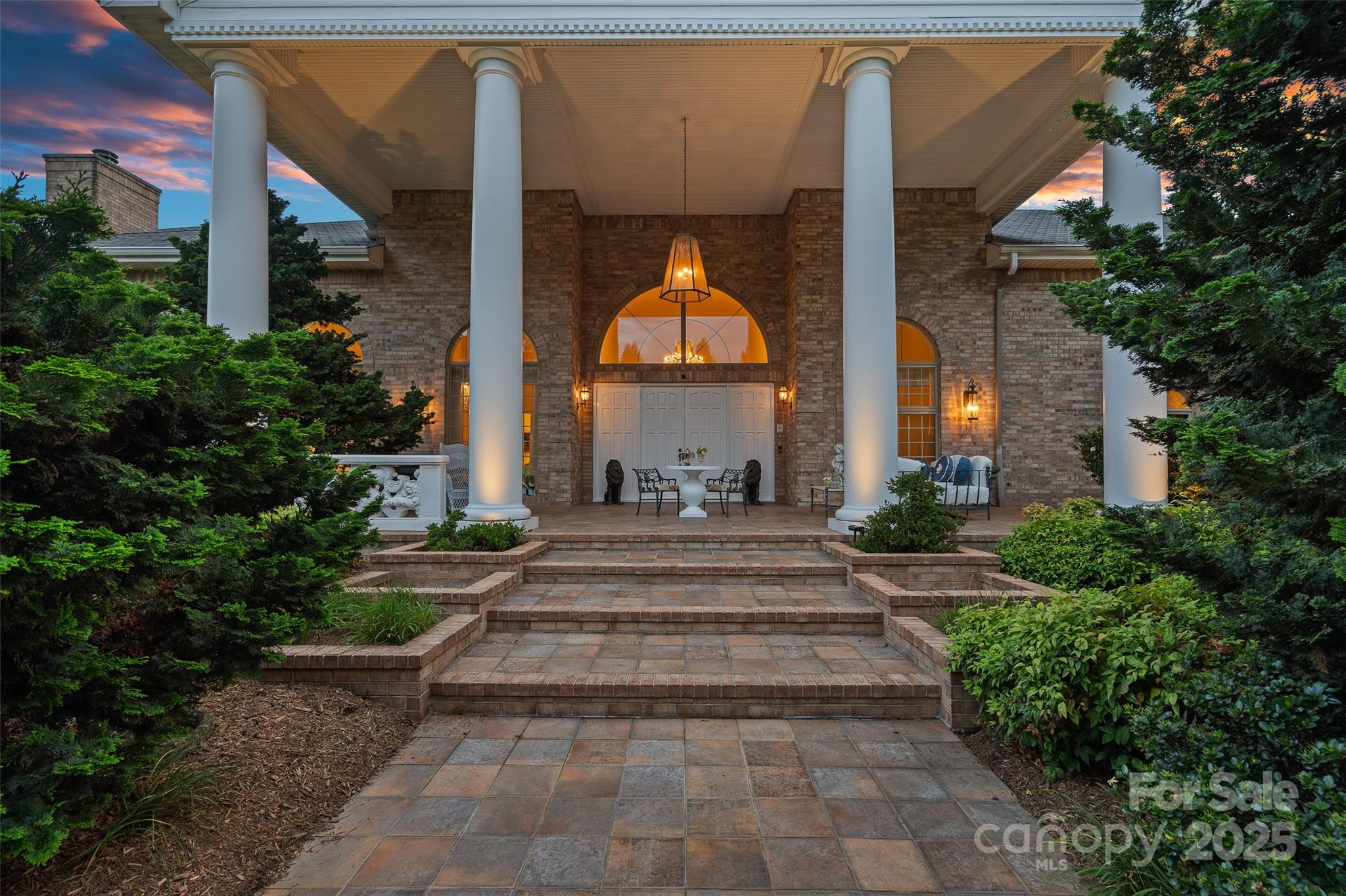 282 Hamilton Drive Columbus, NC 28722 - Photo 38 of 46 a view of a house with large windows and a flower garden