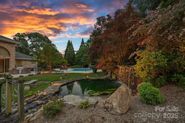 a view of backyard with seating area and green space