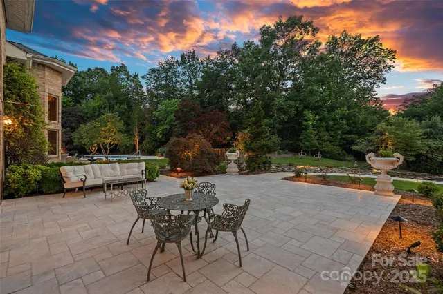 a backyard of a house with table and chairs