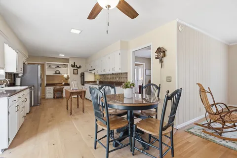 a view of a dining room with furniture and a kitchen