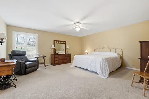 a bedroom with a bed furniture and a window