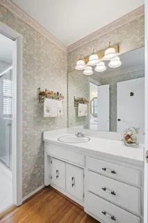 a bathroom with a sink vanity and mirror