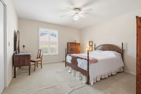 a bedroom with a bed and a chair