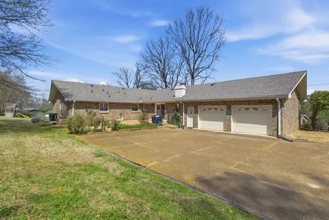 a front view of a building with a yard and garage