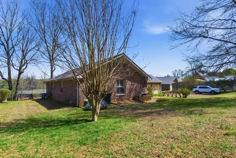 a front view of house with yard and green space