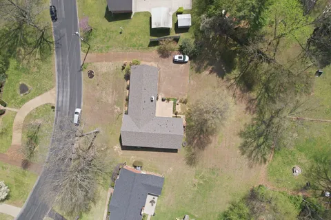 an aerial view of a house with a yard