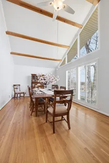 a view of a dining room with furniture and wooden floor