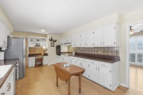 a kitchen with a sink a stove and a refrigerator