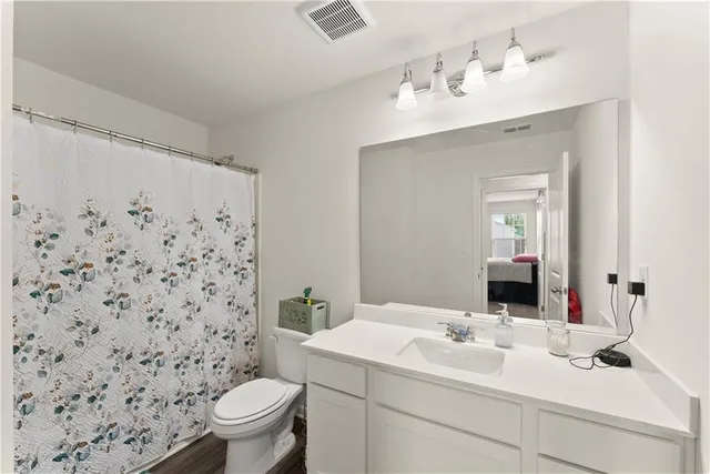 a bathroom with a sink toilet and a mirror