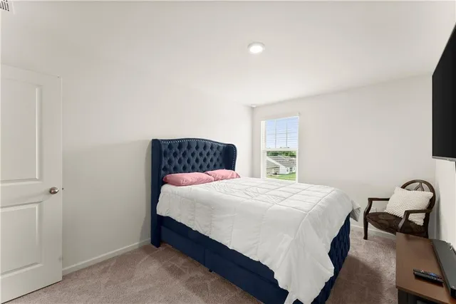 a bedroom with a bed and chair