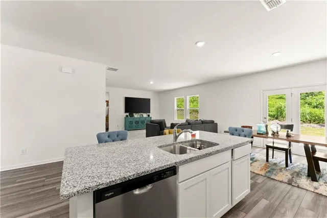 a kitchen with sink and view living room