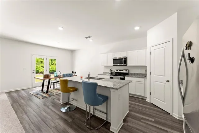 a view of a kitchen with sink and microwave